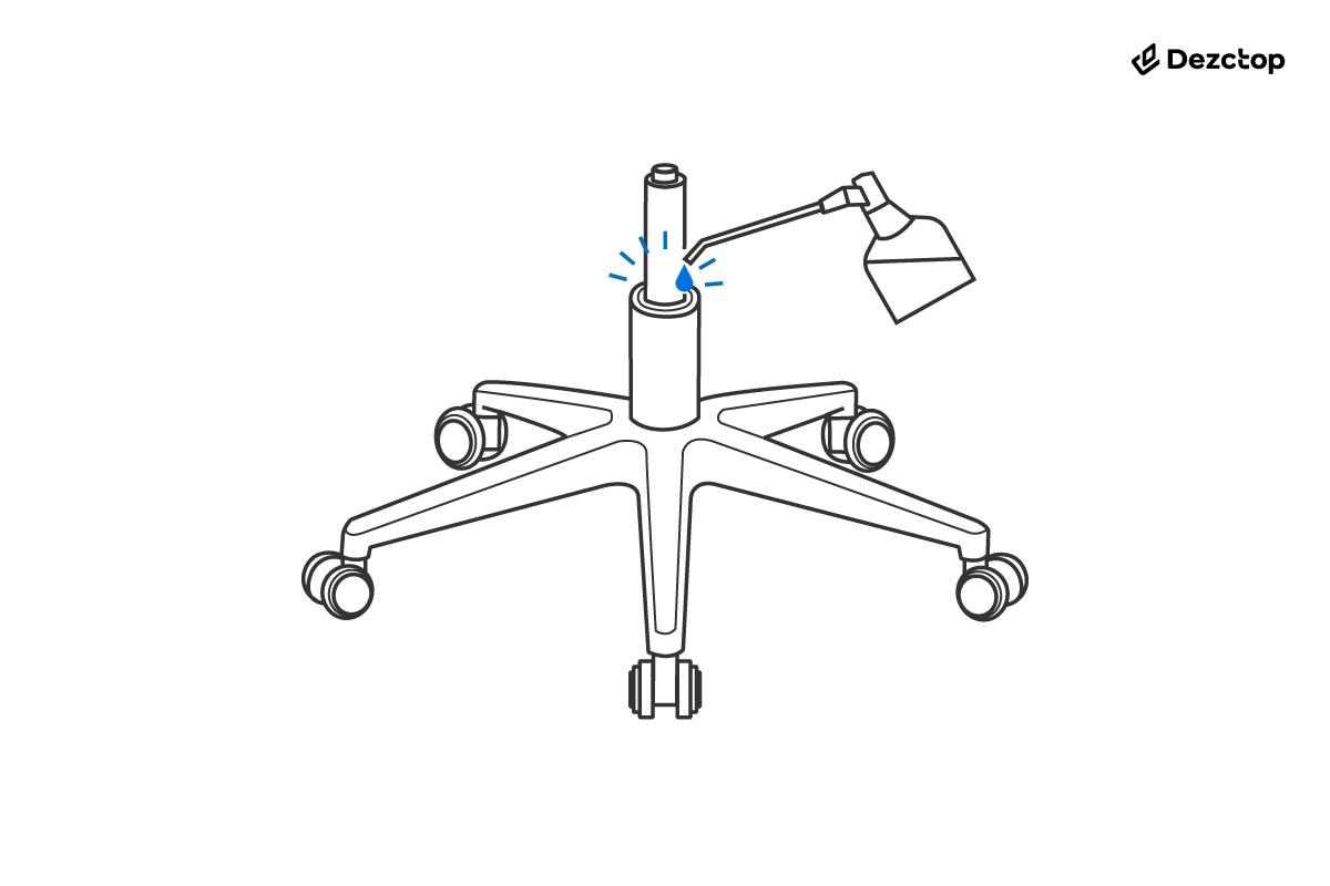 Office chair base with five caster wheels and exposed gas lift cylinder, shown with a lubricant spray nozzle applying oil at the connection point.