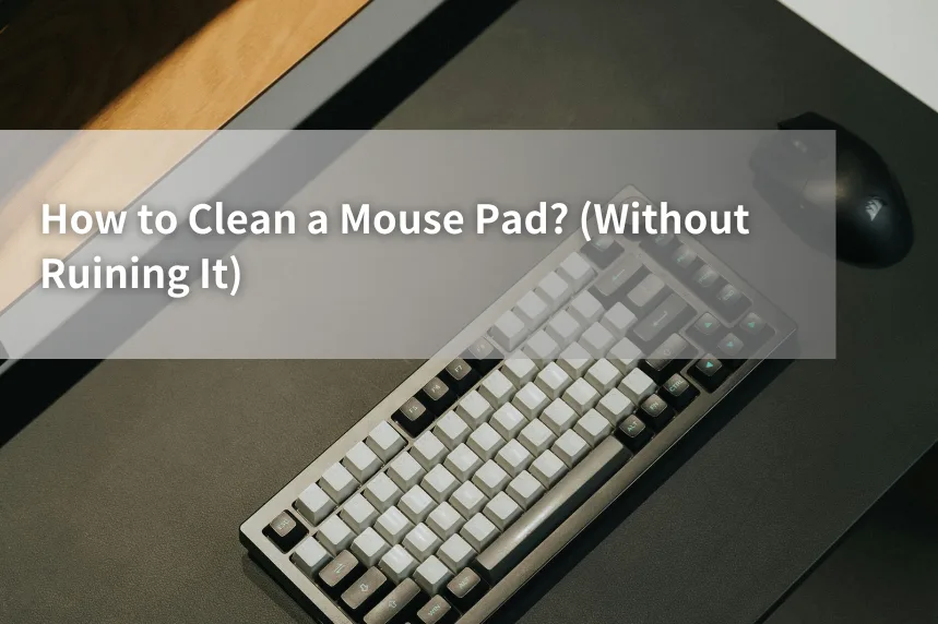 Guide cover image showing a keyboard and mouse on a large black desk mat with the title text “How to Clean a Mouse Pad? (Without Ruining It)” – mouse pad cleaning tutorial