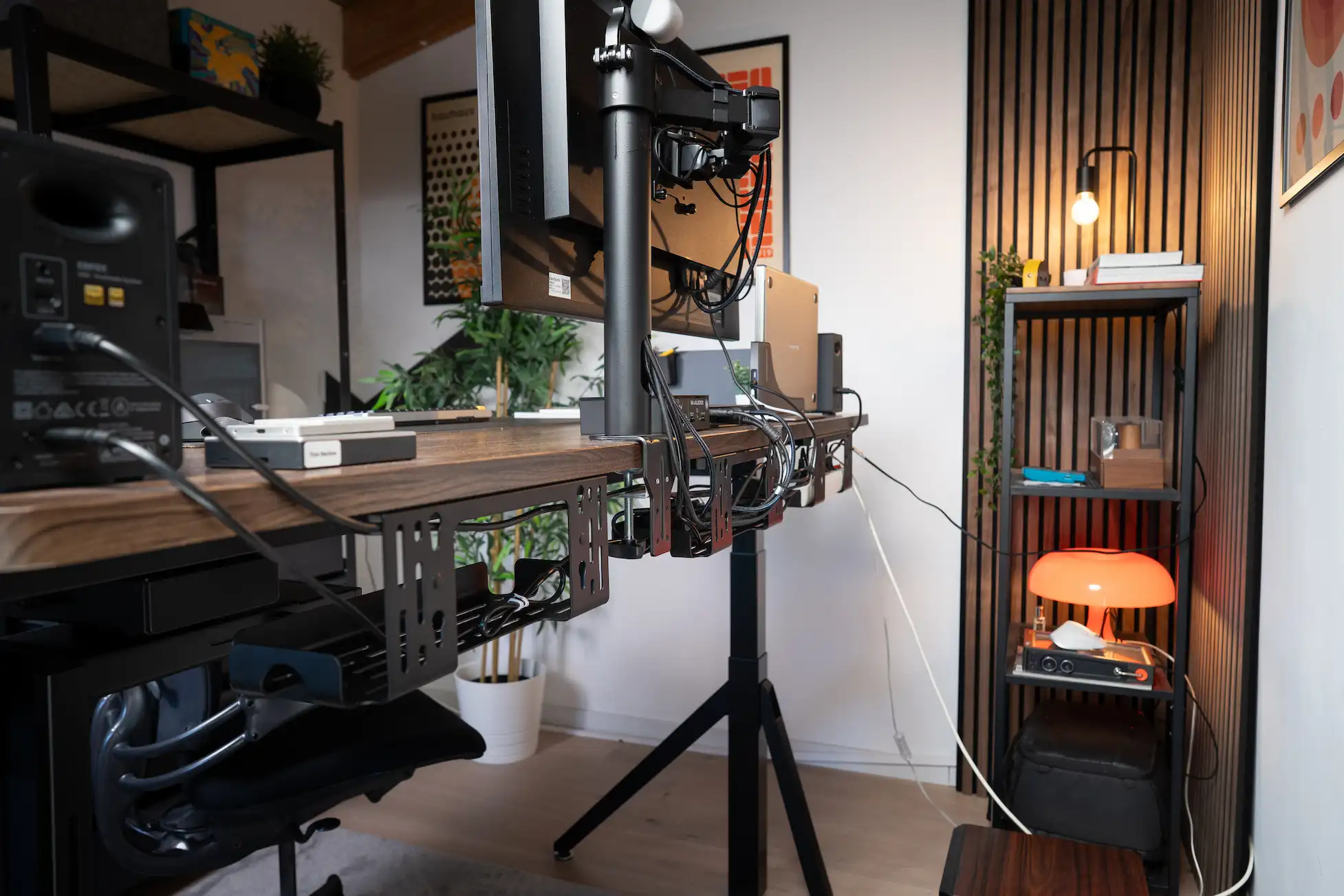 Wide view of a Revon standing desk with multiple cable trays supporting cables Wide view of a Revon standing desk with multiple cable trays supporting cables