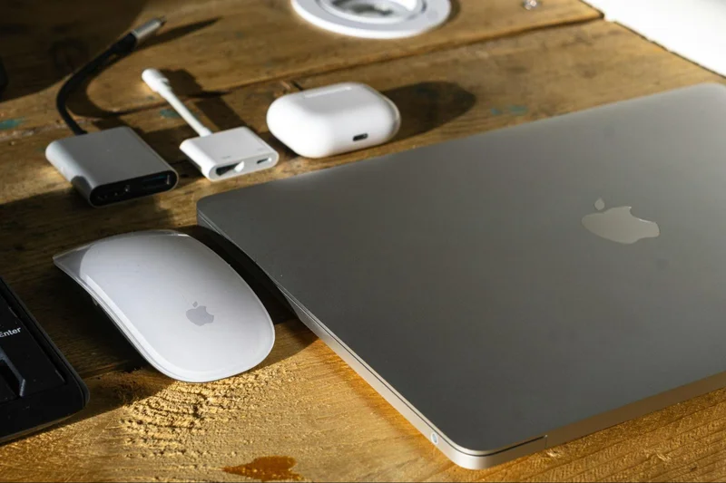 A silver laptop computer and mouse, perfect for a productive home office or remote work setup.